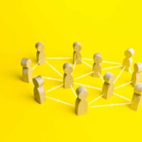 People connected by lines on a yellow background. Self-organized hierarchical business company